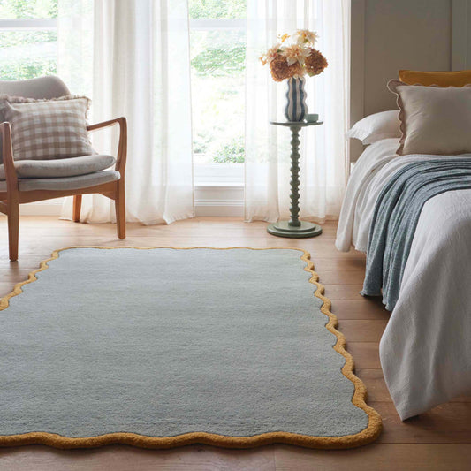 Scalloped Elise Duck Egg Ochre Rug - a 100% wool blue rug featuring a scalloped yellow border.