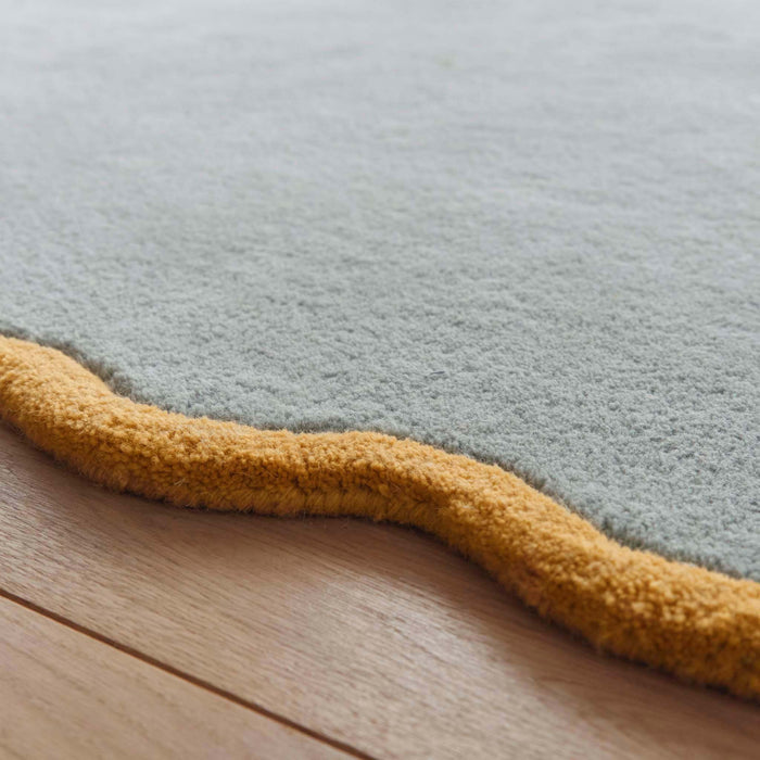 Scalloped Elise Duck Egg Ochre Rug - a 100% wool blue rug featuring a scalloped yellow border.