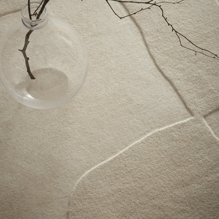 Sculptured Wool Boulder Rug- a 100% wool cut pile rug in Cream with a patterned design.