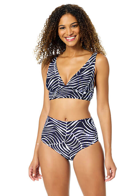 Woman wearing a navy and white patterned bikini on a white background