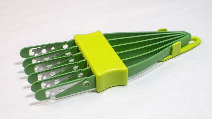 light and dark green 6 blade bread lame or bread scorer with the protectors on the blades