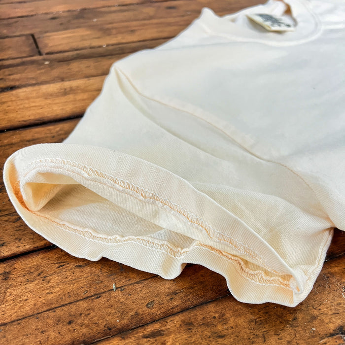 White fabric with scalloped edge on a wooden surface