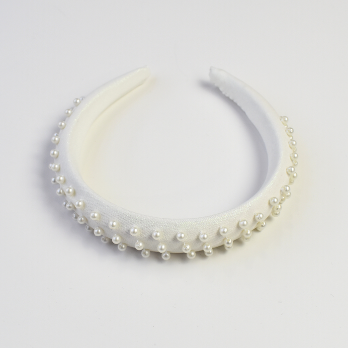 White satin-covered headband for girls, embellished with small pearl beads arranged evenly across the surface, perfect for weddings.