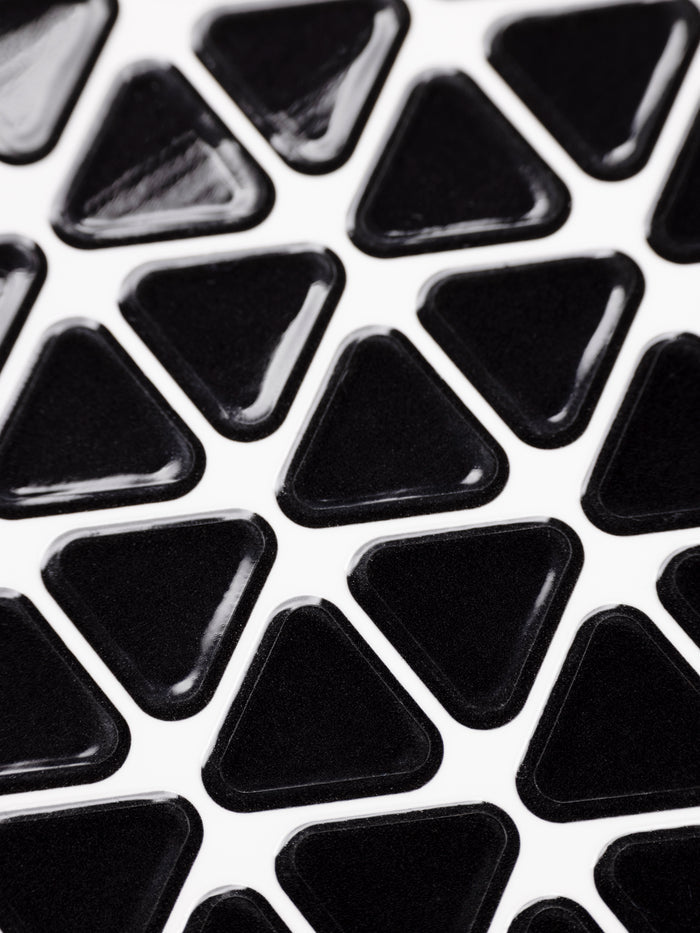 Close up of a sheet of high gloss, black triangle planner stickers