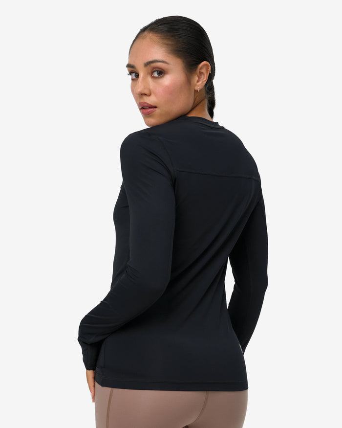 Woman wearing a black long-sleeve top on a white background