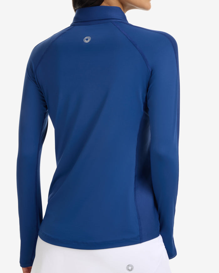 Woman wearing a blue long-sleeve top on a white background