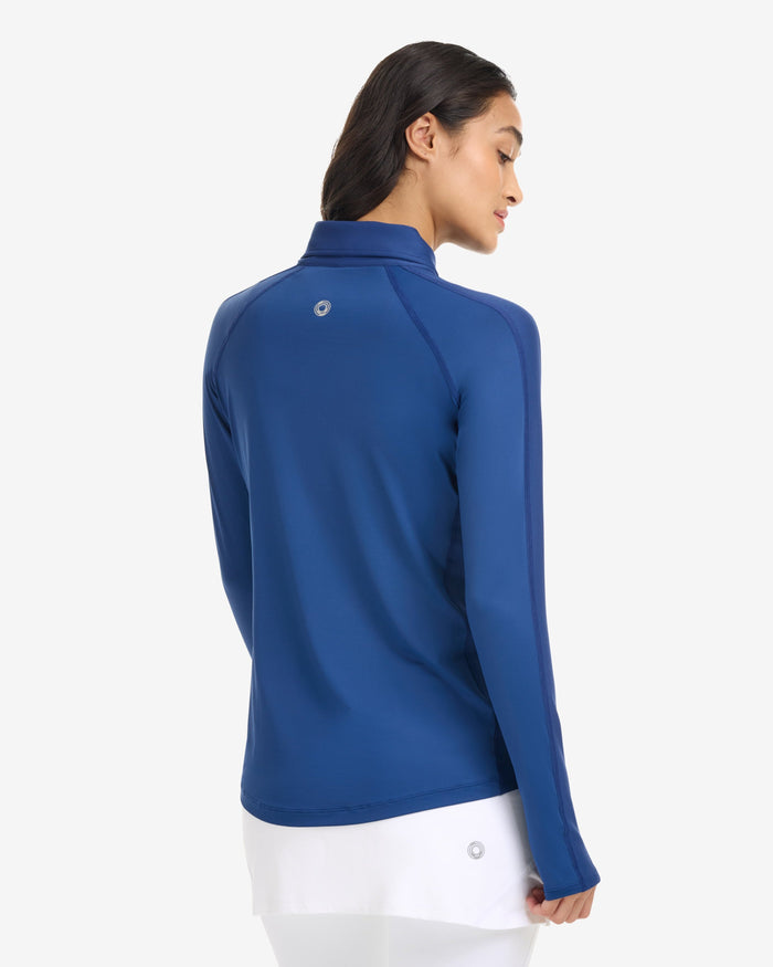 Woman wearing a blue long-sleeve top on a white background