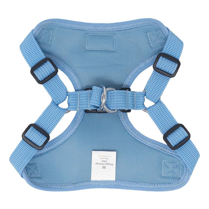 Blue dog harness with black buckles on a white background